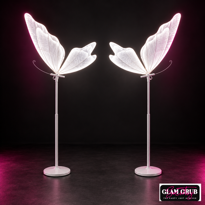The Electric Flutter Neon Duo of two illuminated white butterfly floor props by Glam Grub Society